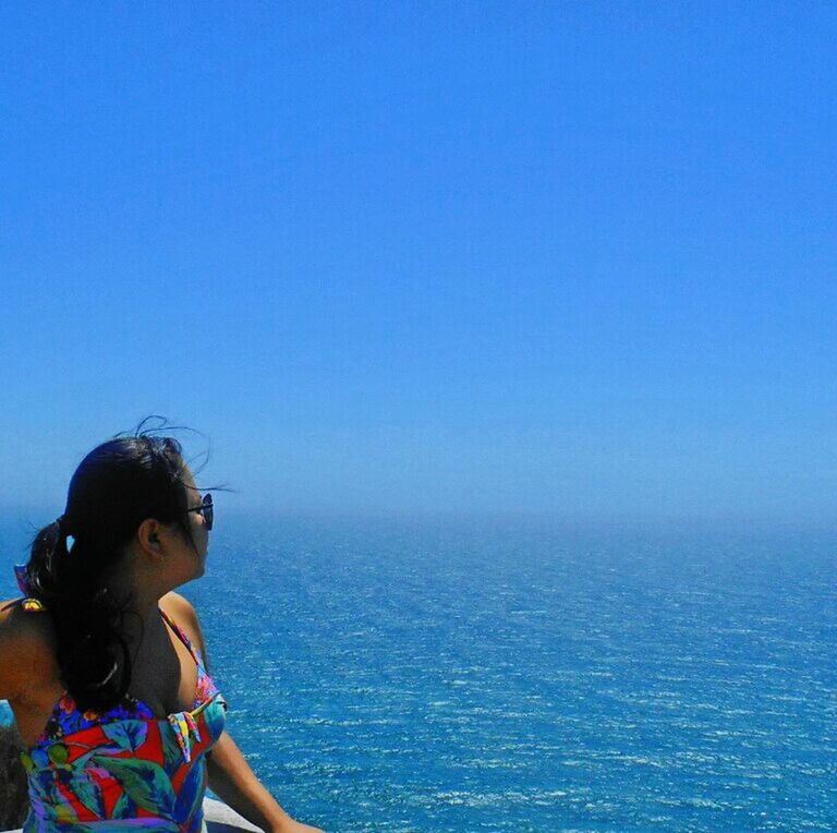 lifestyles, leisure activity, water, sea, blue, young adult, copy space, clear sky, person, young men, vacations, headshot, standing, horizon over water, waterfront, waist up, three quarter length