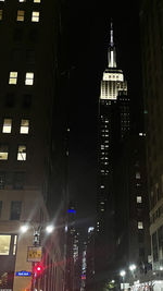 Low angle view of buildings lit up at night
