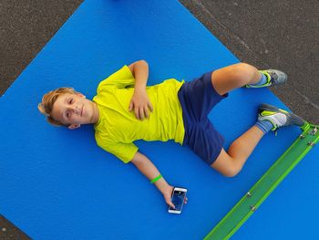 High angle view of woman lying down on floor