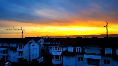 Buildings against sky at sunset