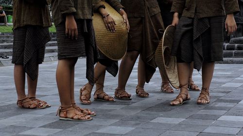 Low section of people standing on street