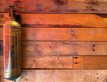 Close-up of old bottles on wooden wall