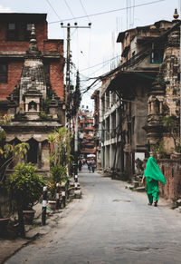 Rear view of people walking on street