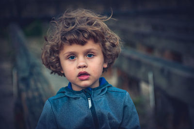 Portrait of cute boy standing outdoors