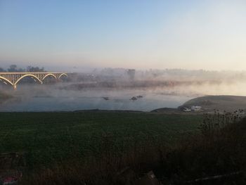 Scenic view of landscape against sky during foggy weather