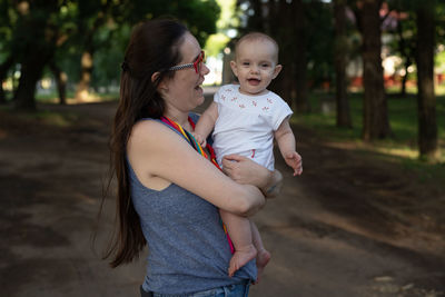 Mother and daughter standing outdoors