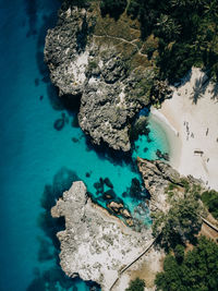 High angle view of rocks by sea