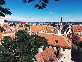 High angle view of houses by sea against sky