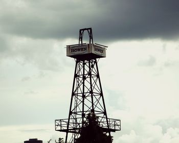 Low angle view of communications tower against sky