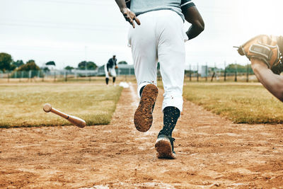 Low section of man exercising on field