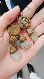 Close-up of hand holding wind chime