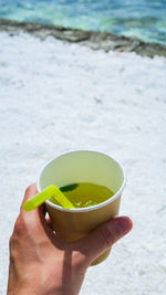 Close-up of hand holding tea cup