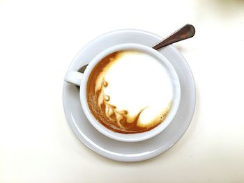 Close-up high angle view of coffee cup on white background