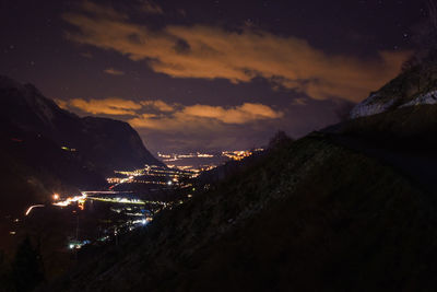 Aerial view of illuminated city against sky at night