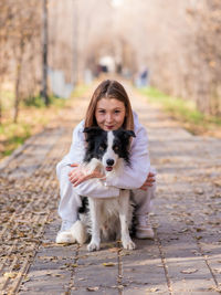 Portrait of dog running on footpath