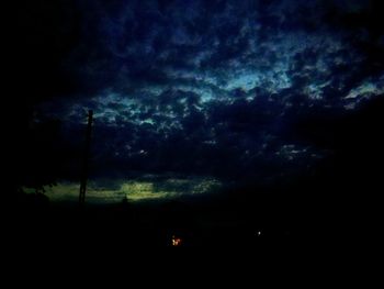 Silhouette trees against sky at night