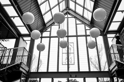Low angle view of pendant lights hanging on ceiling in building