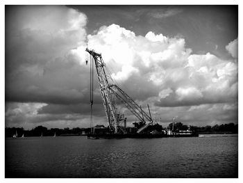 Crane against cloudy sky