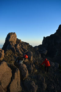Rocks on mountain against clear blue sky