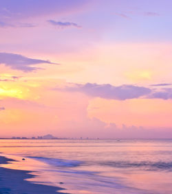 Scenic view of sea against romantic sky at sunset