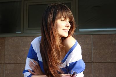 Portrait of beautiful young woman looking away