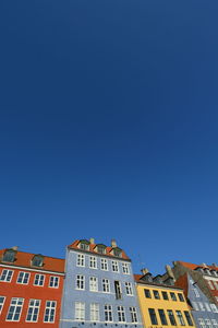 Low angle view of building against clear blue sky