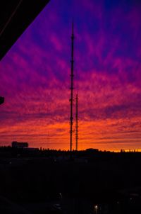 Silhouette electricity pylon against sky during sunset