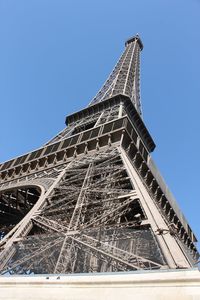 Low angle view of tower against blue sky