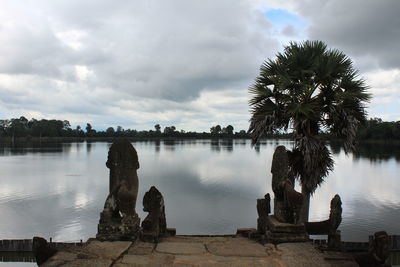 Scenic view of lake against cloudy sky