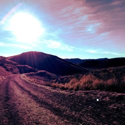 Scenic view of mountains against cloudy sky
