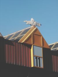 Low angle view of built structure against clear blue sky