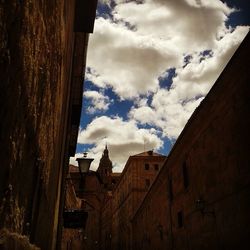 Buildings against cloudy sky