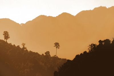 Scenic view of silhouette mountains against sky during sunset