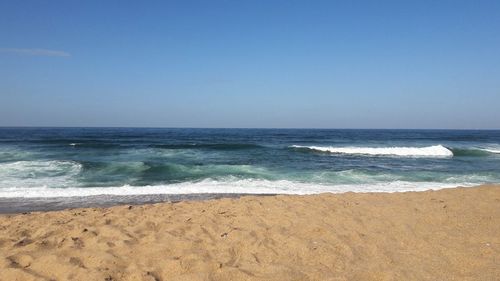 Scenic view of beach against clear sky