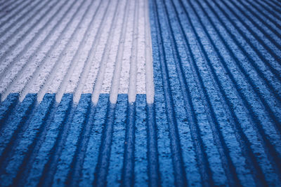 Full frame shot of white and blue parallel striped surface