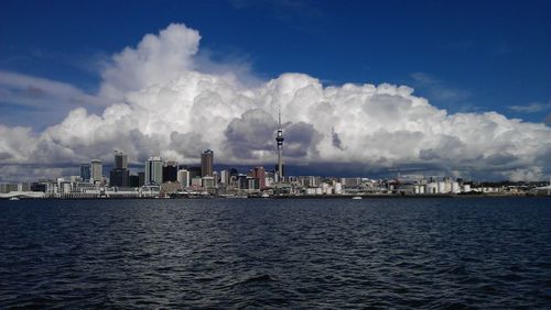 Panoramic view of sea and cityscape against sky