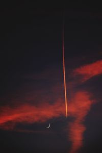 Low angle view of vapor trail against sky at night