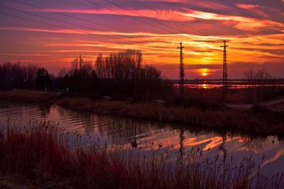 Scenic view of lake against romantic sky at sunset