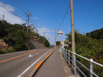 Road by bridge against sky