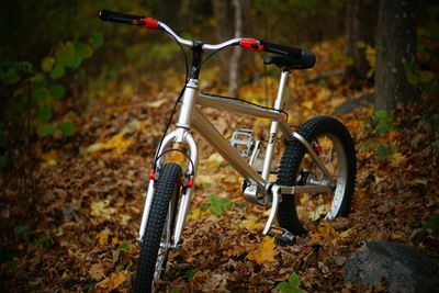 Close-up of bicycle on field in forest