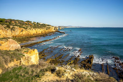 Scenic view of sea against clear blue sky