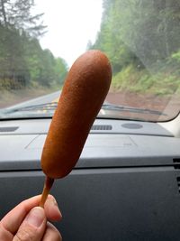 Close-up of hand holding ice cream cone in car