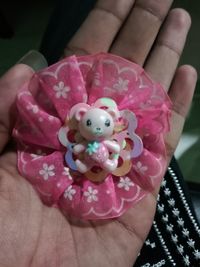 Close-up of hand holding pink flowers