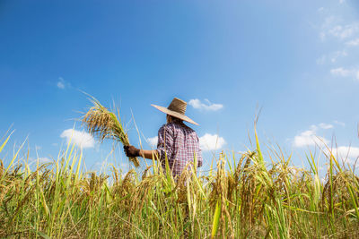 Person in field against sky