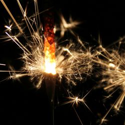 Low angle view of firework display at night