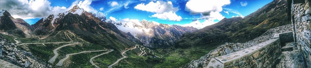 Panoramic view of mountains against cloudy sky