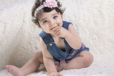 Portrait of cute girl sitting outdoors