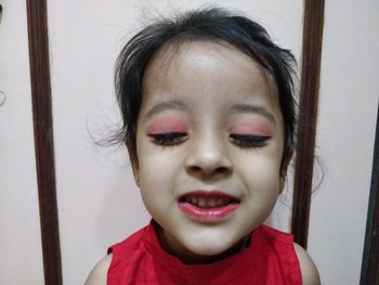 Close-up portrait of cute girl at home