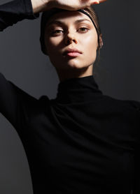 Side view of man wearing hat against black background
