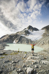 Rear view of backpacker looking at beautiful mountain view.